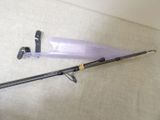 a purple umbrella that is on the floor next to a black pole