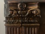 a clock that is on the side of a wooden cabinet