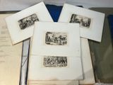 several old books are sitting on a table with pictures on them