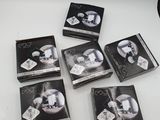 six boxes of black and white photos of a man and woman
