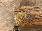 a wooden box with a skull on it on a table
