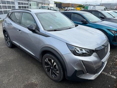 a silver car parked in a parking lot next to other cars