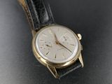 an image of a wrist watch on a black surface