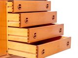 a wooden cabinet with four drawers on it