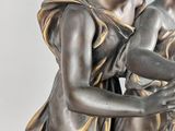 a statue of a boy and a girl holding a bird