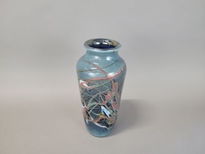 a blue vase that is sitting on a table