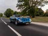 a blue car that is driving down the road