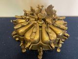 a gold plate with a group of people sitting on top of it