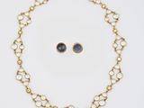 a necklace and earring set in 18k yellow gold