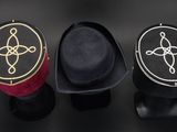 three hats are lined up on top of each other on a table