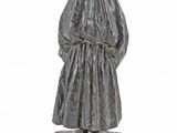 statue of a man in a robe and hat standing on a rock