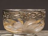 a close up of a bowl on a table with a black background