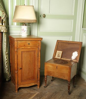 une petite table sur laquelle est posée une lampe, à côté d'une chaise