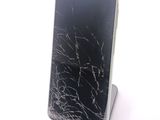 a broken cell phone sitting on top of a stand
