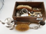 a wooden box filled with silverware and a brush