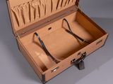 a brown suitcase with two handles and a handle in it