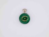 a close up of a green christmas ornament on a white surface