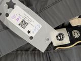 the label on the jacket is attached to a pair of shoes