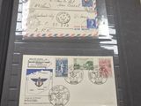 two envelopes with stamps on them sitting on a table
