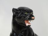 a statue of a black panther with its mouth open