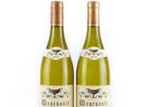 two bottles of wine sitting next to each other on a white surface