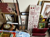 a pile of art on the floor next to a lamp