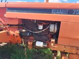 a tractor that is sitting in the grass by itself