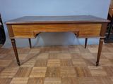 a wooden desk with a drawer on it on a hard wood floor