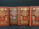 three books are lined up in a row on a black background