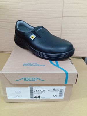 black leather shoes with rubber outs and rubber outs are on top of a cardboard box