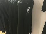 clothes hanging on a clothes rack in a clothing store