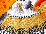 a painting of a gold helmet on a leopard print table cloth