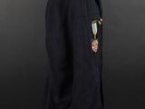 a black coat with a medal on the lapel