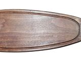 a fish shaped cutting board with a wooden board on it