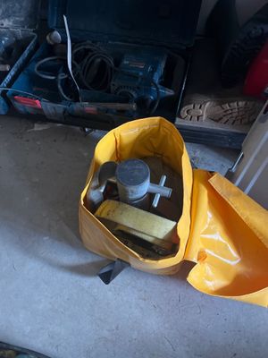 a yellow bag with tools in it sitting on the floor