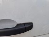 a close up of a door handle on a white car