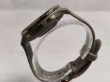 a close up of a watch sitting on top of a clear case