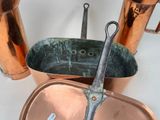 a pair of scissors sitting in a copper pot