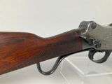 a close up of a rifle on display in a glass case