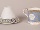 two cups and a saucer are sitting next to each other on a table