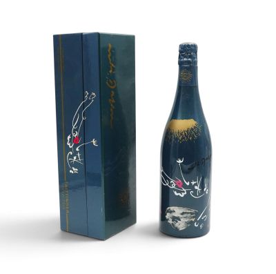 a bottle of wine that is sitting next to a box