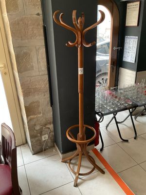 a coat rack and a table in the corner of a room