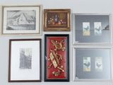 many framed pictures on the wall of a room