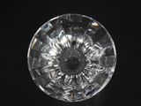 the top view of a clear glass object on a black surface