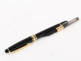 a black and gold pen sitting on top of a white surface