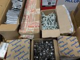 many boxes of screws and bolts on the ground