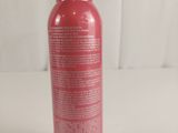 a close up of a bottle of body lotion on a white surface