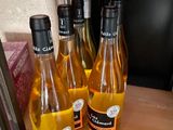 four bottles of wine sitting on a shelf next to each other