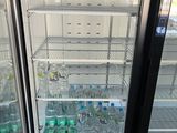 a refrigerator with several bottles of water inside of it