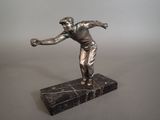a statue of a man throwing a baseball on a marble base